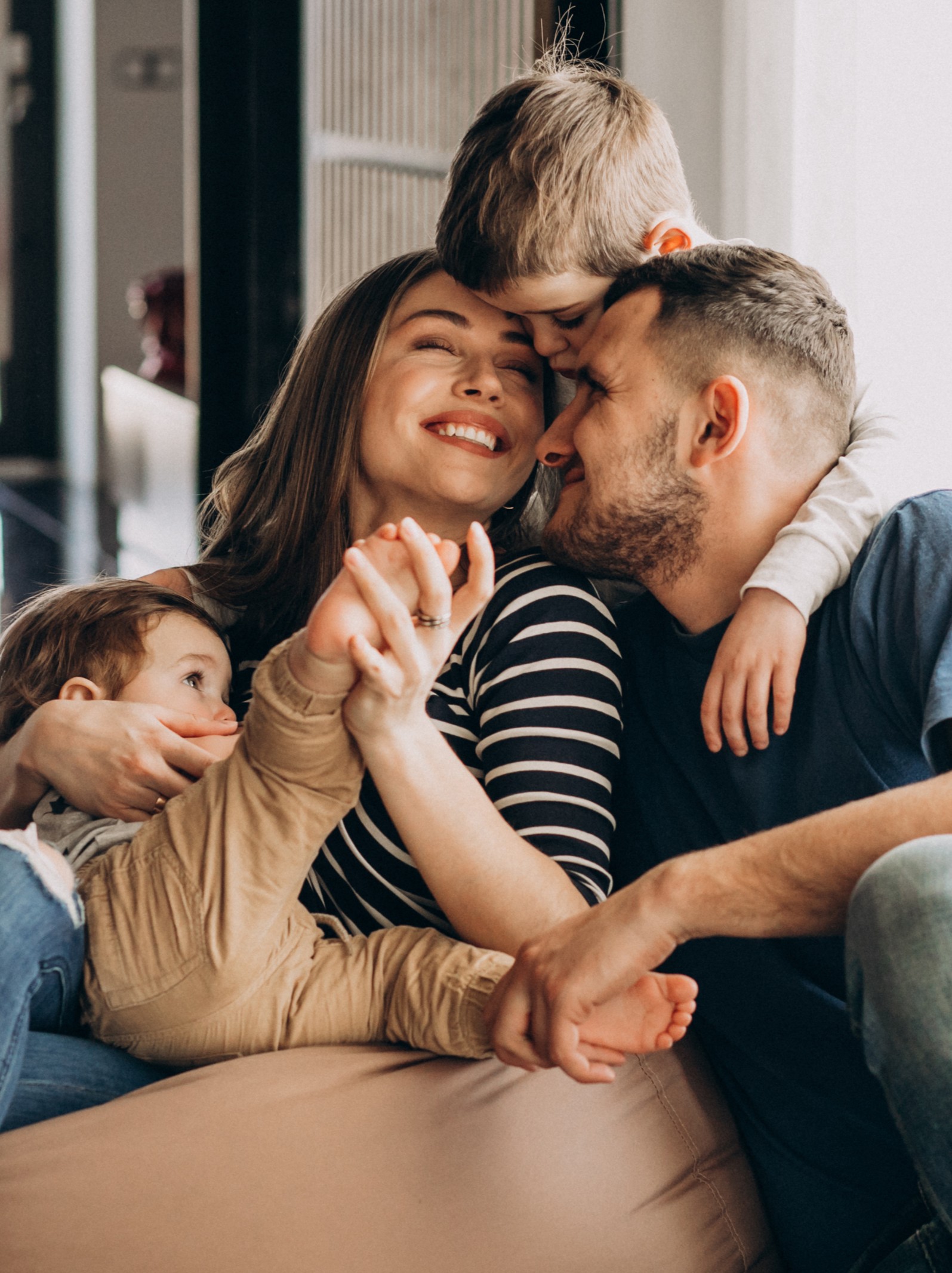 Young family with their sons at home having fun